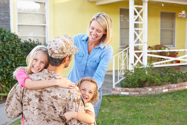 Photo of Young Marine and family with home and financial security from 1031 Exchange investing.