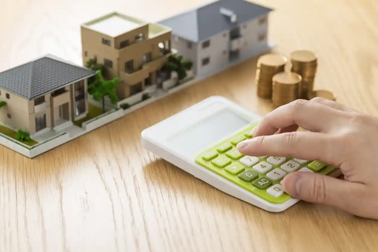 iStock-1180932025 Image of model of commercial property and an electronic caculator